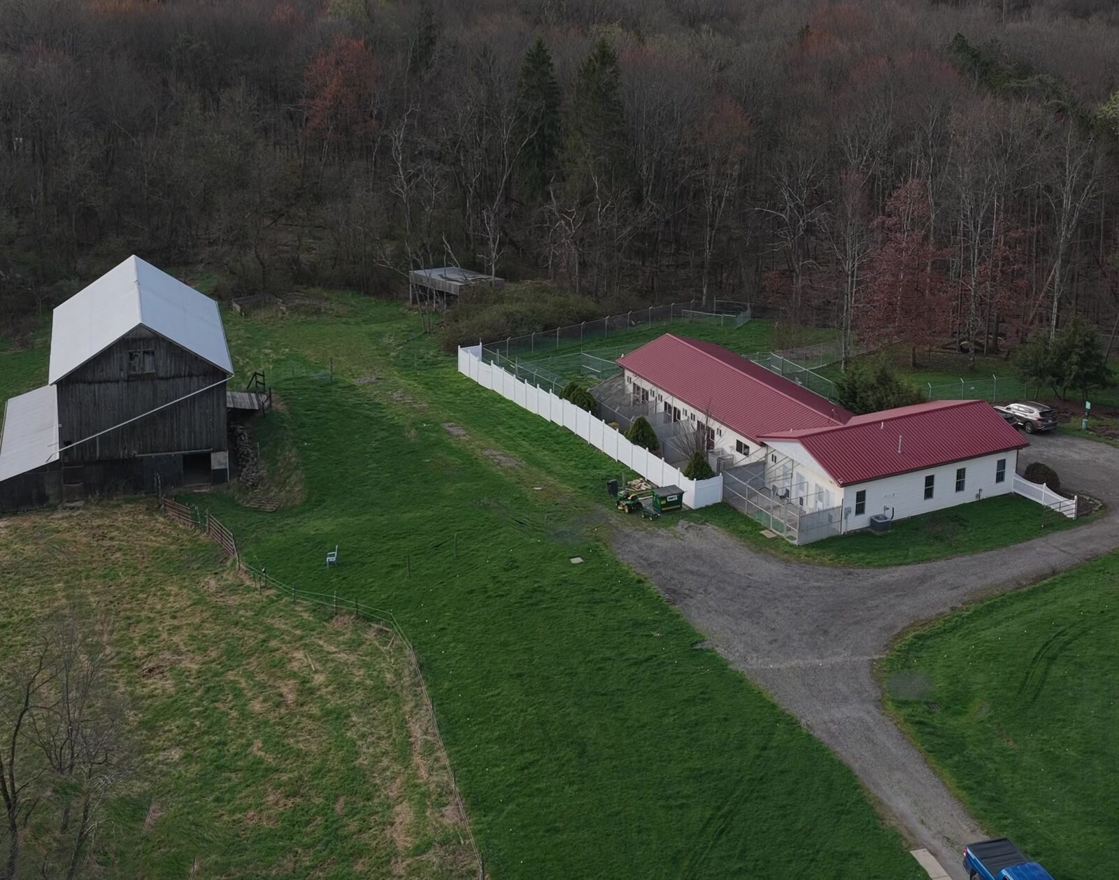 Aerial view of the Boujee Barn Pet Resort farm — historic barn, resort building, and rolling countryside in Georgetown, PA